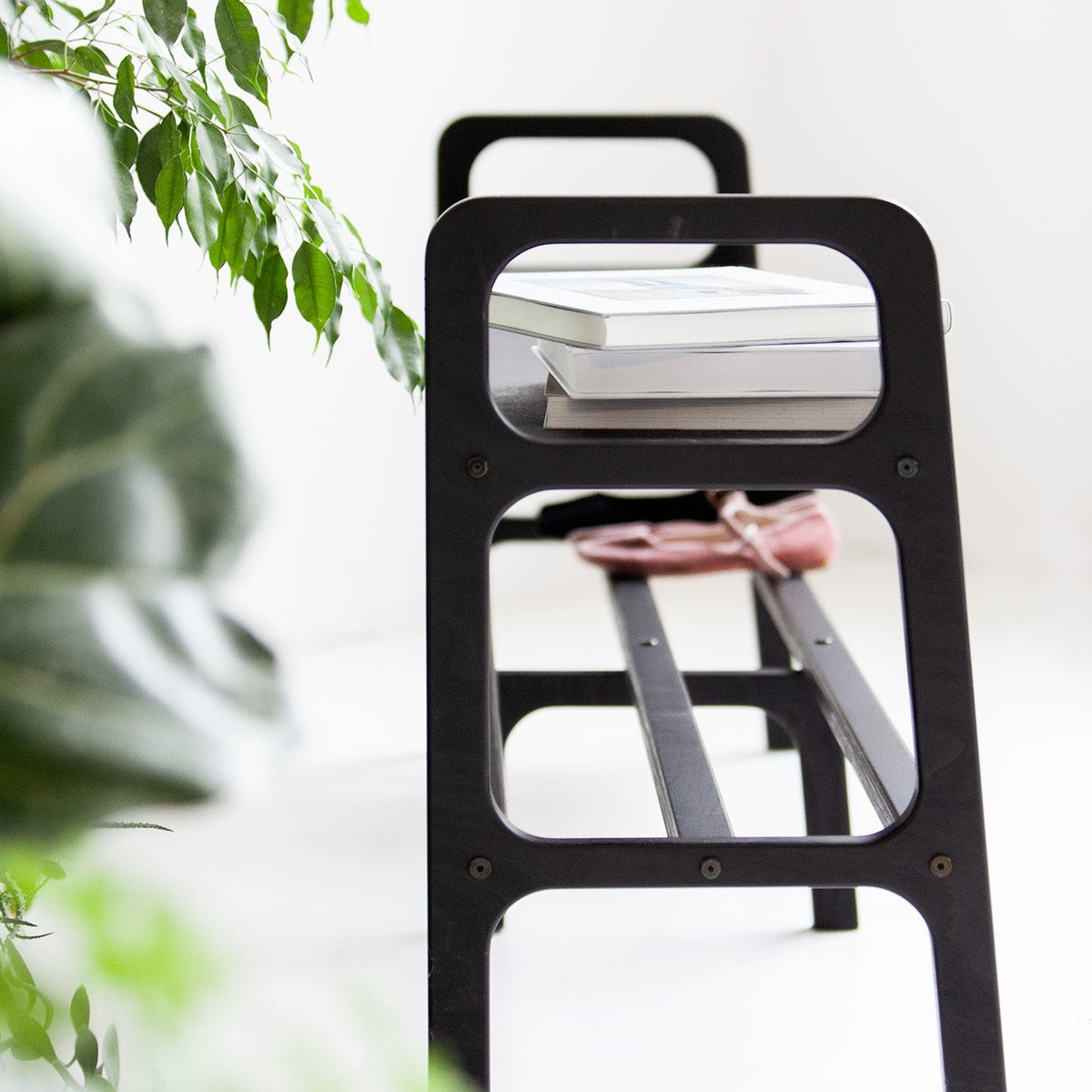mid-century-modern-wooden-bench-in-light-background-side-view